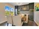 Elegant dining room with a stylish light fixture, wine storage, and large window at 16410 Good Hearth Blvd, Clermont, FL 34711