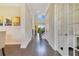 Well-lit hallway with hardwood floors, showcasing the home's elegant design and inviting atmosphere at 16410 Good Hearth Blvd, Clermont, FL 34711