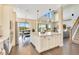 Bright and airy kitchen with a spacious island, modern lighting, and an adjacent dining area with picturesque outdoor views at 16410 Good Hearth Blvd, Clermont, FL 34711