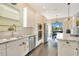 Well-appointed kitchen with stainless steel appliances, white cabinets, granite counters, and a view to the dining area at 16410 Good Hearth Blvd, Clermont, FL 34711