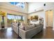 Spacious living room with soaring ceilings, large windows offering scenic views, and a comfortable seating area at 16410 Good Hearth Blvd, Clermont, FL 34711