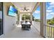 Screened patio featuring a table and chairs, ceiling fan, and a mounted television at 16410 Good Hearth Blvd, Clermont, FL 34711
