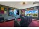 Home theater with large screen, comfortable seating, and window with a view at 16410 Good Hearth Blvd, Clermont, FL 34711