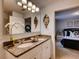 Bathroom featuring a double sink vanity with granite countertops and updated fixtures and mirror at 17081 Water Spring Blvd, Winter Garden, FL 34787