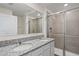Bathroom with double sink vanity with granite countertops, and glass-enclosed tiled shower at 17081 Water Spring Blvd, Winter Garden, FL 34787