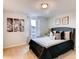 Cozy bedroom featuring a gray headboard and decorative pillows, with natural light filtering through the window at 17081 Water Spring Blvd, Winter Garden, FL 34787