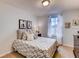 Comfortable bedroom with a large window, soft lighting, neutral carpet and stylish decor at 17081 Water Spring Blvd, Winter Garden, FL 34787