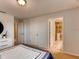 Well-lit bedroom featuring an open doorway to an ensuite bathroom with a glass enclosed shower at 17081 Water Spring Blvd, Winter Garden, FL 34787