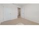 Carpeted bedroom with two doors, light streaming in, and neutral decor at 17081 Water Spring Blvd, Winter Garden, FL 34787