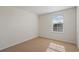 This bedroom has a large window with neutral carpet and white trim at 17081 Water Spring Blvd, Winter Garden, FL 34787