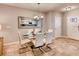 Bright dining area with a glass table set for six, adjacent to the kitchen at 17081 Water Spring Blvd, Winter Garden, FL 34787