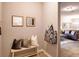 Welcoming entryway with bench seating, decorative pillows, and a glimpse into the cozy living room at 17081 Water Spring Blvd, Winter Garden, FL 34787