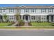 Charming townhome featuring a well-manicured lawn, gray shutters, and a covered entrance at 17081 Water Spring Blvd, Winter Garden, FL 34787