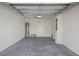 Unfinished garage with concrete floor, water heater, and electrical panel at 17081 Water Spring Blvd, Winter Garden, FL 34787