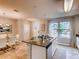 Modern kitchen island with bar seating and stainless steel sink at 17081 Water Spring Blvd, Winter Garden, FL 34787