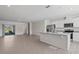 Open-concept kitchen and living space features stainless appliances, granite countertops, and ample natural light at 17081 Water Spring Blvd, Winter Garden, FL 34787