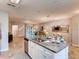 Open-concept kitchen with island, stainless steel appliances, granite countertops, and seamless flow into the living areas at 17081 Water Spring Blvd, Winter Garden, FL 34787