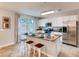 Bright kitchen features stainless steel appliances and a granite-topped center island with bar seating at 17081 Water Spring Blvd, Winter Garden, FL 34787