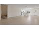 Spacious living room showcasing tile flooring, staircase, and bright, open layout leading to the kitchen at 17081 Water Spring Blvd, Winter Garden, FL 34787