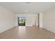 Bright living area with tile flooring, neutral walls, and sliding glass door at 17081 Water Spring Blvd, Winter Garden, FL 34787