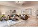 Inviting living room showcasing neutral tones, stylish furniture, a decorative mirror, and adjacent dining area at 17081 Water Spring Blvd, Winter Garden, FL 34787