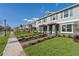Charming street view of new townhomes with well-kept lawns and inviting front entrances at 17081 Water Spring Blvd, Winter Garden, FL 34787