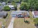 Charming single-story home featuring a well-maintained yard and a long driveway leading to an attached garage at 186 Tulpan Dr, Kissimmee, FL 34743