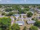 Neighborhood aerial featuring a single-story home and circular street with mature trees and well-kept lawns at 186 Tulpan Dr, Kissimmee, FL 34743