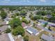 Aerial view showcasing a well-established neighborhood with tree-lined streets and manicured lawns at 186 Tulpan Dr, Kissimmee, FL 34743