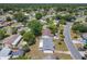 Neighborhood view of a cozy, single-story home with a large backyard surrounded by lush green trees at 186 Tulpan Dr, Kissimmee, FL 34743