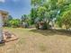 Spacious backyard featuring mature trees, providing plenty of shade and a serene outdoor space at 186 Tulpan Dr, Kissimmee, FL 34743