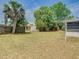 Large backyard with a mix of trees and open space, offering great potential for outdoor activities at 186 Tulpan Dr, Kissimmee, FL 34743