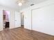 This bedroom features neutral walls, a closet, and laminate flooring throughout at 186 Tulpan Dr, Kissimmee, FL 34743