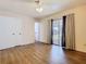 This bedroom features a closet, sliding glass door, and laminate flooring throughout at 186 Tulpan Dr, Kissimmee, FL 34743