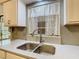 Updated kitchen featuring gray subway tile backsplash, newer countertops, and modern stainless steel faucet at 186 Tulpan Dr, Kissimmee, FL 34743
