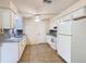 Bright eat in kitchen featuring white cabinets, tile flooring, and neutral colored countertops and backsplash at 186 Tulpan Dr, Kissimmee, FL 34743
