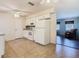 Efficient kitchen featuring white appliances, tile flooring, and an adjacent living space at 186 Tulpan Dr, Kissimmee, FL 34743