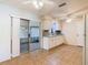 Eat in kitchen showcasing white cabinetry, a ceiling fan, tile flooring, and sliding doors to a screened in lanai at 186 Tulpan Dr, Kissimmee, FL 34743