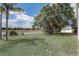 Lush backyard with large trees and views of a tranquil pond, perfect for relaxation at 19540 Glen Elm Way, Orlando, FL 32833