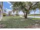 Large backyard featuring mature trees with lake views, creating a serene outdoor oasis at 19540 Glen Elm Way, Orlando, FL 32833