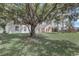 Expansive backyard with mature trees and lush green lawn, perfect for outdoor activities and relaxation at 19540 Glen Elm Way, Orlando, FL 32833