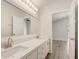 Bright primary bathroom features double sinks, quartz counters, and a large mirror at 19540 Glen Elm Way, Orlando, FL 32833