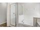 This bathroom is equipped with a glass door shower and a luxurious soaking tub at 19540 Glen Elm Way, Orlando, FL 32833