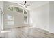 Bright bedroom with a ceiling fan, large windows, and laminate flooring throughout at 19540 Glen Elm Way, Orlando, FL 32833