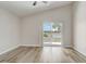 Open bedroom with wood-look flooring and a sliding door that leads to the backyard at 19540 Glen Elm Way, Orlando, FL 32833