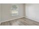Cozy bedroom with wood-look flooring, natural light, and a neutral color palette at 19540 Glen Elm Way, Orlando, FL 32833