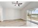 Spacious bedroom with wood-look flooring, sliding glass doors, and scenic backyard view at 19540 Glen Elm Way, Orlando, FL 32833