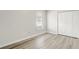 Light-filled bedroom featuring a closet, window and wood-look flooring at 19540 Glen Elm Way, Orlando, FL 32833
