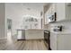 Open kitchen with stainless steel appliances, quartz countertops, and open access to the living room at 19540 Glen Elm Way, Orlando, FL 32833