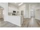 Well-lit kitchen featuring quartz countertops, stainless appliances, and open access to the house at 19540 Glen Elm Way, Orlando, FL 32833
